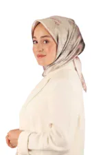 Elegant woman wearing a silk hijab with a floral pattern, dressed in a cream-colored blazer, showcasing modest fashion and Turkish textiles, representative of Shop of Turkey's diverse product range.