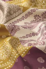 Soft Turkish bandana with traditional paisley and floral patterns in yellow, white, and purple, perfect for fashion accessories or home decor.