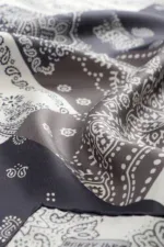 Black and white bandana pattern, classic paisley design on silk fabric.