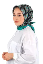 Elegant woman wearing a vibrant, patterned silk scarf with floral motifs, styled as a headscarf, paired with a white blouse, showcasing traditional Turkish fashion and high-quality craftsmanship.
