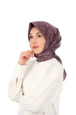 Elegant woman wearing a silky patterned headscarf and white blouse, showcasing Turkish fashion and headwear styles. Perfect for modest fashion enthusiasts from Turkey and around the world.