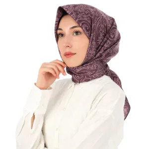 Elegant woman wearing a silky patterned headscarf and white blouse, showcasing Turkish fashion and headwear styles. Perfect for modest fashion enthusiasts from Turkey and around the world.