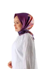 Elegant woman wearing a vibrant purple and floral silk hijab, showcasing stylish modest fashion from Turkey, perfect for modern and traditional wear.