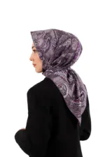 Elegant woman wearing a purple patterned silk scarf styled as a hijab, showcasing stylish modest fashion accessories for women. Perfect for daily wear or special occasions, combining comfort and sophistication.