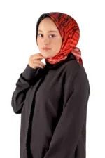Elegant woman wearing a red and black patterned silk hijab and a black jacket, showcasing modest fashion from Turkey. Perfect for stylish, comfortable, and fast-shipping Turkish apparel shopping.