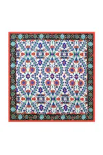 Vibrant Turkish ceramic tile with intricate floral and geometric patterns in blue, red, green, and black, showcasing traditional handcrafted art from Turkey.