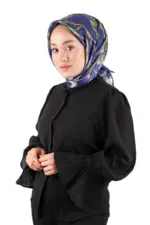 Silk patterned headscarf with blue, green, and beige hues worn by a woman in a black blouse, showcasing Turkish fashion and cultural elegance.