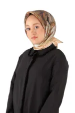 Elegant woman wearing a beige and brown marbled silk headscarf and a stylish black coat, showcasing Turkish fashion and accessories. Perfect for shoppers interested in traditional and modern Turkish apparel.