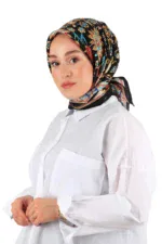 Vibrant floral patterned silk headscarf styled on a woman wearing a white shirt, showcasing elegant Turkish fashion accessories.