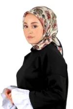Elegant woman wearing a traditional patterned silk hijab and modern black blouse with white sleeves, showcasing modest fashion from Turkey, ideal for cultural and stylish apparel shopping.
