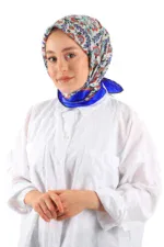 Elegant woman wearing a colorful floral silk headscarf and white chef coat, representing Turkish fashion and cuisine. Perfect for online shopping at Shop of Turkey for authentic products and fast shipping.