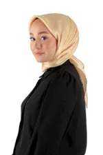 Soft beige silk hijab worn by a woman with smooth skin, contemporary style, and elegant look, showcasing premium Turkish fabric from Shop of Turkey.