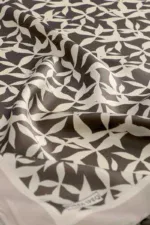 Black and white patterned fabric featuring an abstract leaf design, perfect for home decor or sewing projects, showcasing high-quality material with a modern aesthetic.