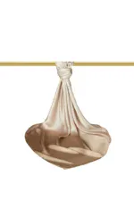 Silk fabric tied with a knot, hanging from a gold rod, on a clean white background.