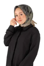 Silk-patterned hijab paired with a black jacket, stylish modest fashion accessory for women.