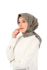 Elegant woman wearing a patterned silk hijab and white blouse, showcasing traditional Turkish fashion with modern style. Perfect for cultural and fashion enthusiasts.