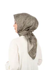 Luxurious taupe silk headscarf with intricate swirling floral patterns, styled on a model with a white blouse for elegant modest fashion. Perfect for adding sophistication to any outfit.