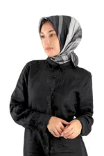 Black silk shirt with a classic collar and button-down front, stylishly paired with a gray-striped satin hijab, creating an elegant look.