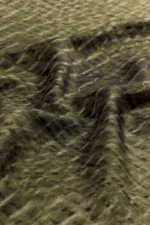 Vintage green camouflage fabric with a textured, wavy surface for military or outdoor use. Perfect for tactical gear, clothing, or decorative purposes showcasing durable, patterned material.