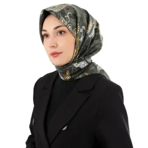 Stylish woman wearing a patterned silk hijab and a black blazer, showcasing Turkish fashion and accessories for women, on a white background.