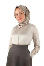 Elegant woman wearing a beige satin blouse and a patterned hijab, showcasing modest fashion from Turkey, perfect for online shopping at Shop of Turkey.