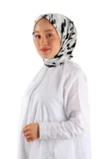 Elegant woman wearing a stylish black and white patterned satin scarf, white long-sleeve blouse, showcasing Turkish fashion and clothing accessories from Shop of Turkey.