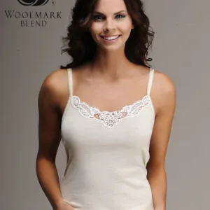 Woolmark Blend logo, close-up of a smiling woman in a white lace-trimmed camisole, highlighting comfortable sleepwear with elegant design, perfect for relaxing or bedtime.