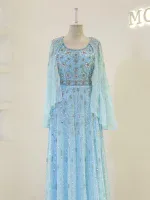 Meticulously crafted traditional dress featuring intricate embroidery and beadwork in soft blue hues, perfect for special occasions and celebrations.