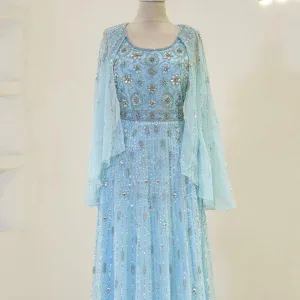 Meticulously crafted traditional dress featuring intricate embroidery and beadwork in soft blue hues, perfect for special occasions and celebrations.