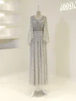 A stunning silver and white embellished gown with intricate beadwork and flowing sheer cape for weddings or special occasions. Features detailed embroidery, long length, and luxurious fabric.