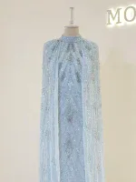 Stunning light blue dress with intricate embroidery and embellishments, displayed on a mannequin. Perfect for special occasions or events.