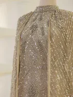 Luxurious gown featuring intricate silver beadwork and sequins on a nude mesh base, creating a glamorous and sophisticated look, perfect for special occasions.