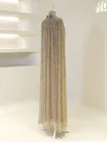 Stunning gold sequin evening gown displayed on a mannequin, perfect for formal events and parties, featuring intricate beadwork and flowing fabric.