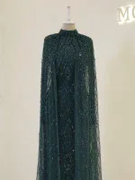 Stunning dark green gown with intricate beading and sequins, perfect for formal occasions. Features a high neckline and flowing cape for a glamorous look.