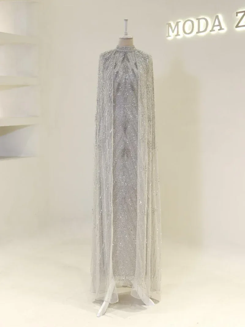 Shimmering silver gown with intricate sequin details and flowing chiffon overlay, perfect for special occasions or glamorous events.