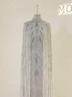 Luxurious white dress featuring intricate beadwork and a flowing cape, perfect for special occasions and celebrations. Available with fast shipping exclusively from Turkey on Shop of Turkey.