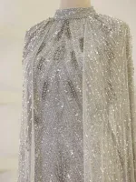 Luxurious white dress adorned with intricate silver beadwork and sequins, showcasing craftsmanship and sparkle, perfect for special occasions and glamorous events.