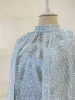 A stunning light blue dress adorned with sparkling silver sequins and embroidery, perfect for formal events or celebrations, emphasizing craftsmanship and elegance.