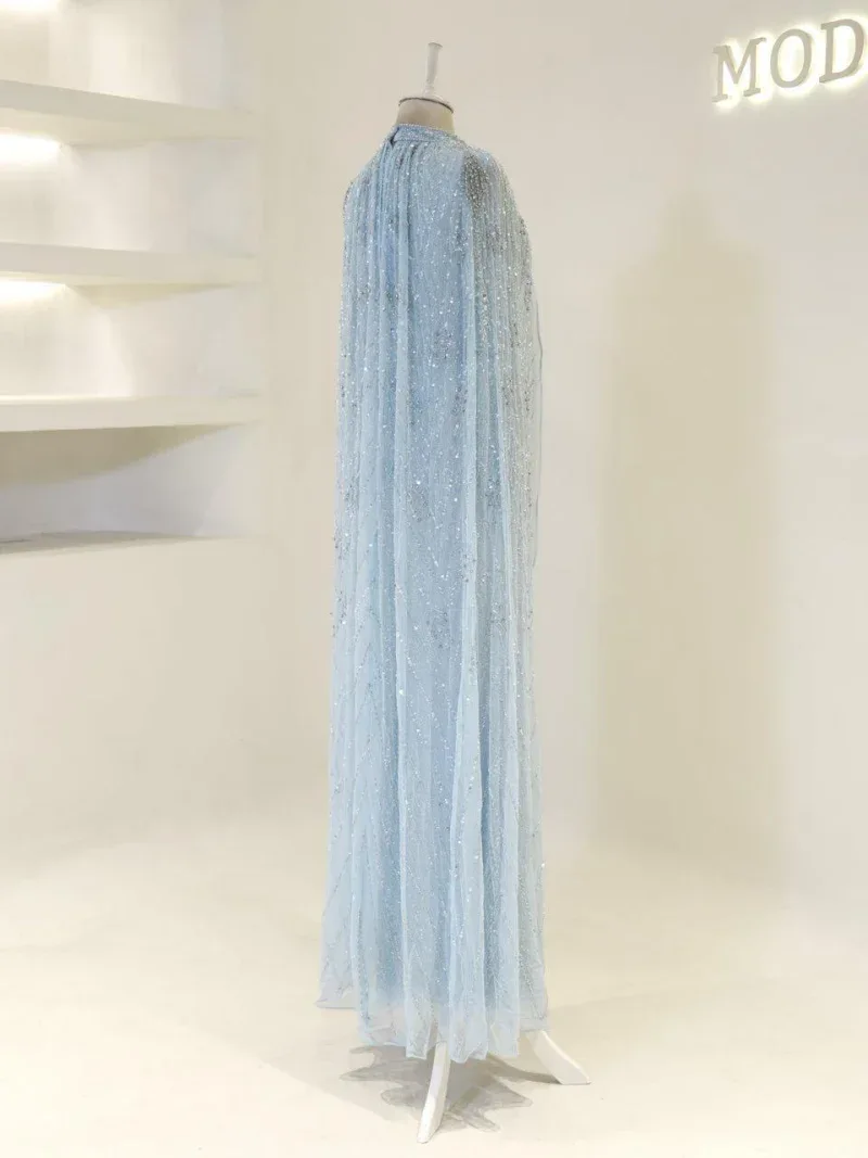 Luxurious light blue gown featuring intricate beadwork and sequins, perfect for special occasions or evening events. Made from delicate, flowing fabric that adds grace and elegance.