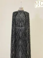 Elegant black and silver beaded evening gown with intricate patterns, high neckline, and long sleeves, perfect for formal occasions and glamorous events.