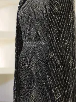 Gorgeous black dress adorned with intricate silver sequins, perfect for special occasions or evening events. Features a fitted silhouette with a shimmering, stylish design.