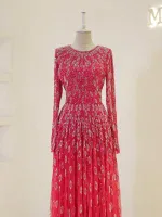 Stunning pink evening gown featuring intricate embroidery and sequins, long sleeves, and a flowing skirt perfect for formal occasions or special events.