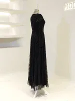 Stunning black evening dress with shimmering sequins, perfect for formal events and celebrations. Fully lined, with an elegant long flowing skirt and fitted silhouette.