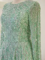 Glamorous green sequin dress with intricate beaded embroidery, long sheer sleeves, and a elegant round neckline, perfect for special occasions.