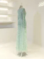 Beautiful long evening gown with shimmering sequins in mint green, perfect for special occasions or parties, designed to make a stunning impression.