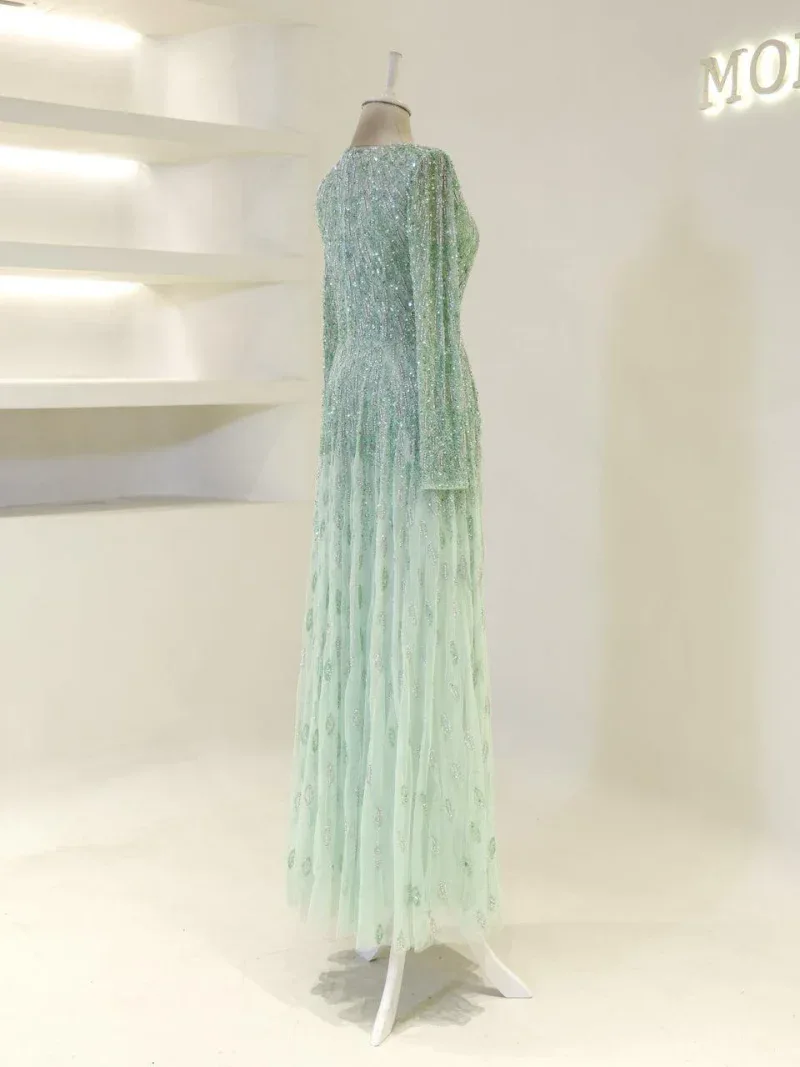 Beautiful long evening gown with shimmering sequins in mint green, perfect for special occasions or parties, designed to make a stunning impression.