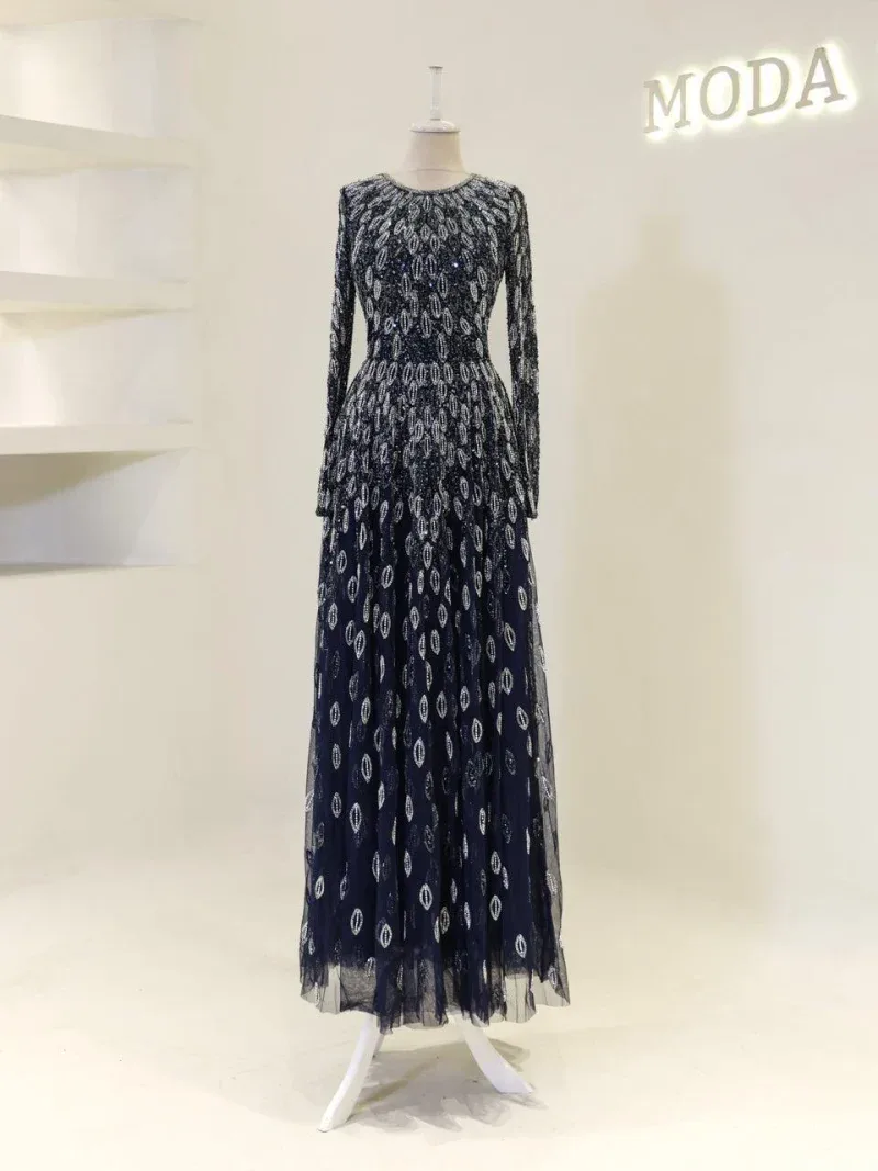 Luxurious navy blue dress with intricate sequin embroidery, long sleeves, and a flowing floor-length skirt, perfect for formal events and special occasions.