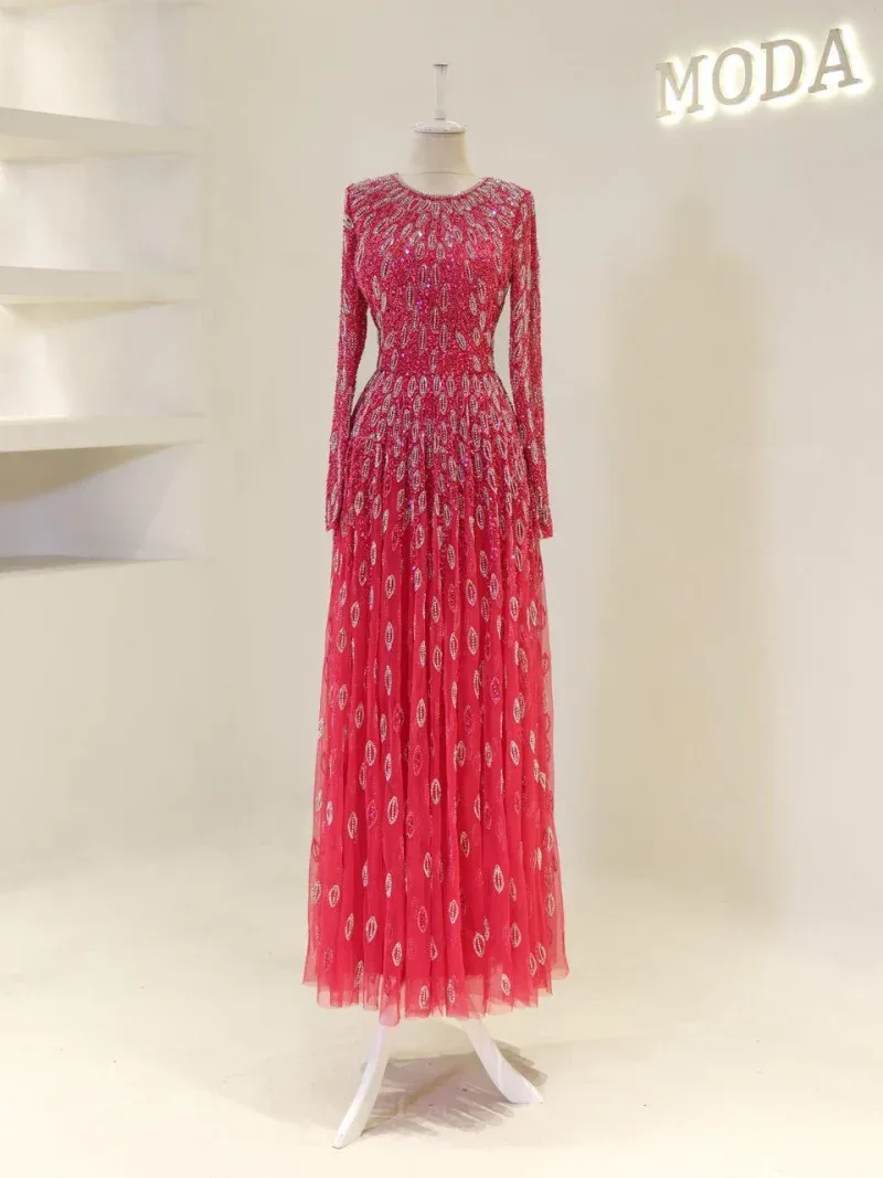 A stunning long pink dress featuring intricate embroidery and shimmering embellishments, ideal for formal events or special occasions.