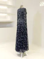 A stunning navy blue maxi dress with detailed silver leaf embroidery, ideal for elegant events and celebrations, showcased on a mannequin in a contemporary retail setting.