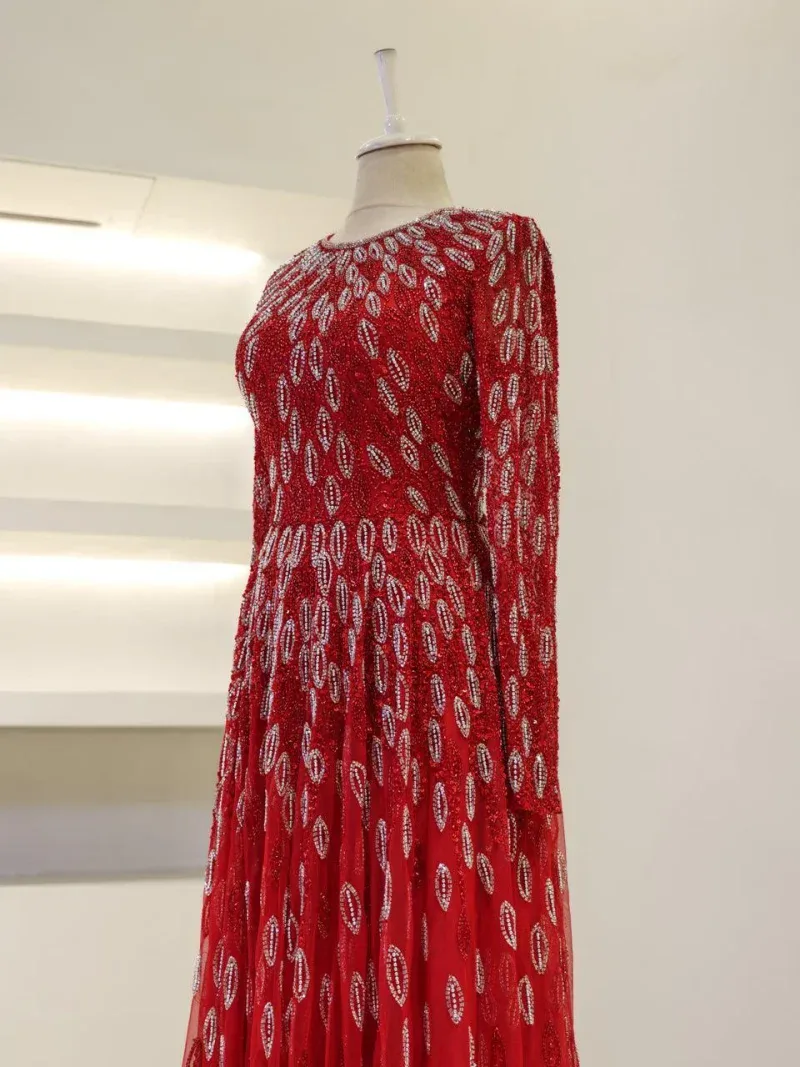 Beautiful red dress featuring intricate silver embroidery and leaf patterns, perfect for special occasions and celebrations. Made with high-quality fabric for a stylish and comfortable fit.